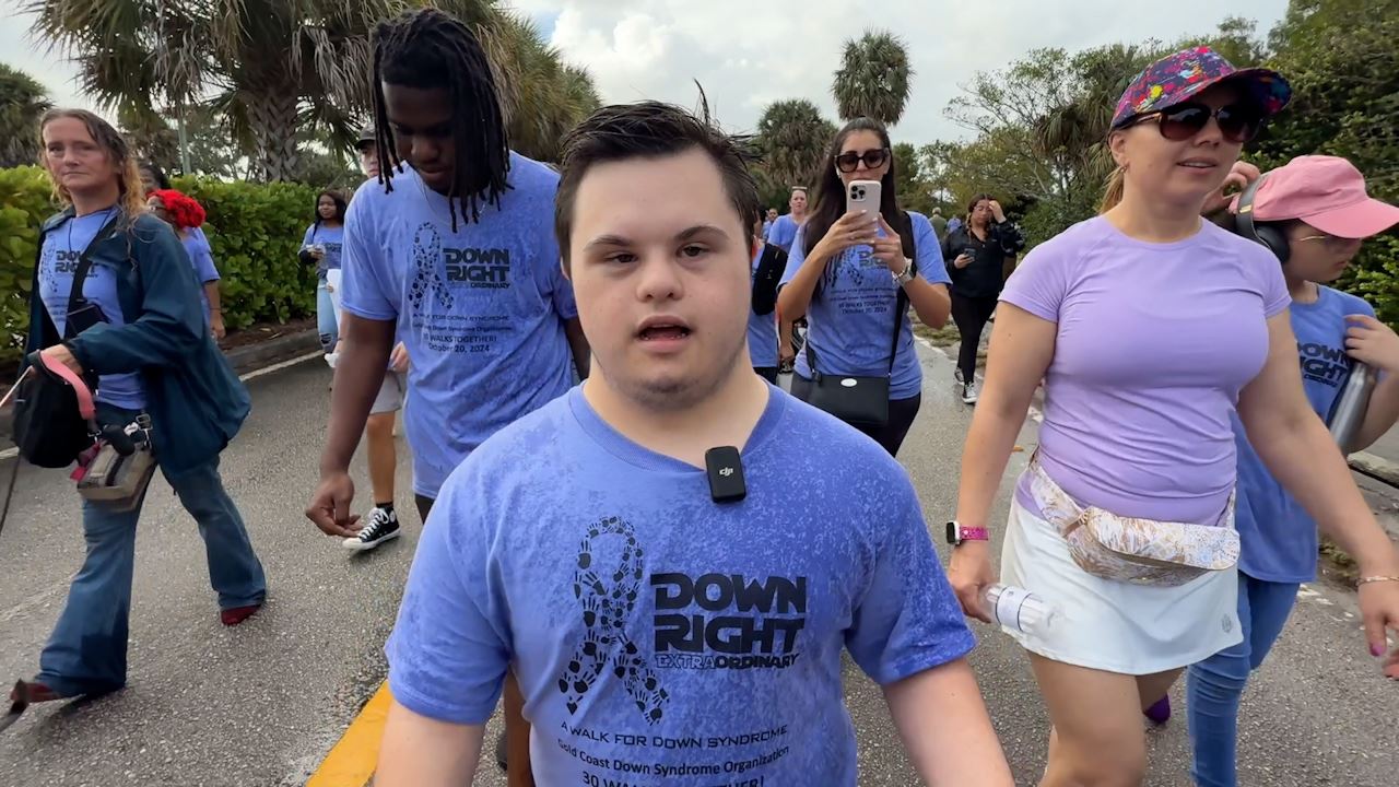  The parents, students, and staff of team Palm Beach walking at the Down Right ExtraOrdinary Walk.